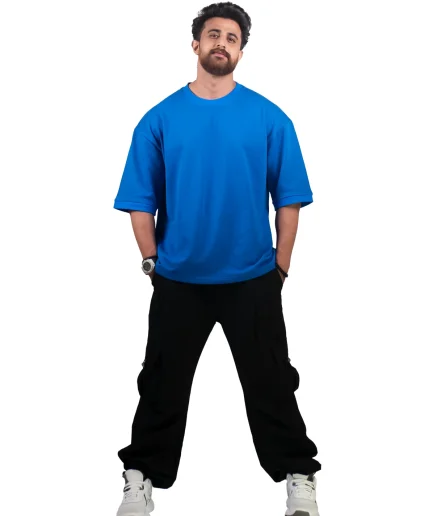 view of sleeves of our royal blue oversize t-shirt showcased by our male model