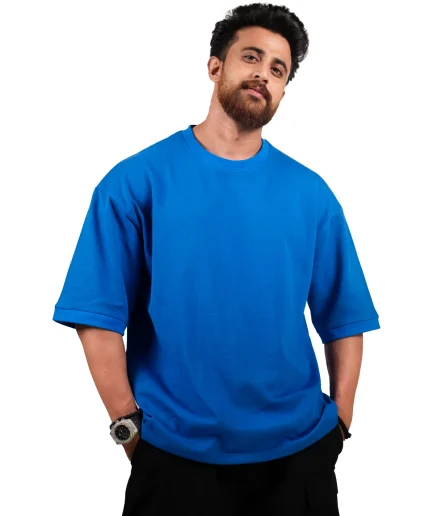 view of sleeves of our royal blue oversize t-shirt showcased by our male model