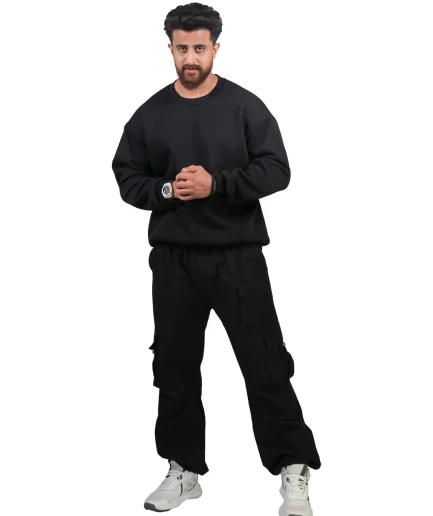 model wearing black oversize sweatshirt and black cargo jogger