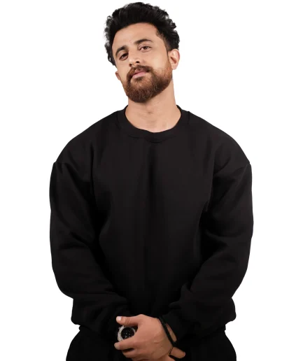 model wearing black oversize sweatshirt and black cargo jogger