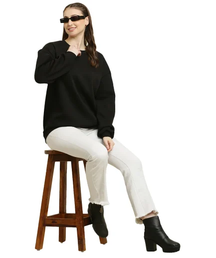 women Black Oversize Sweatshirt showcased by our female model sitting on chair