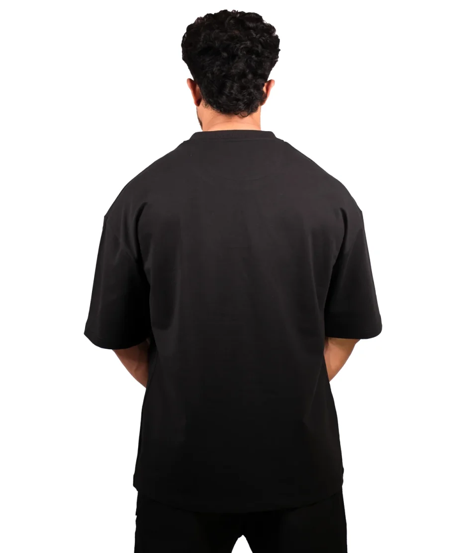 back view of our black oversize t-shirt showcased by our model